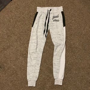 light grey sweat pants, says “Good Vibes” on the front. (most likely for a teen)